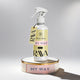 RAVA home spray bottle on a decorative stand with a gray background